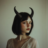 Model wearing elegant 3D printed subtle demon horns for gothic cosplay and Halloween costumes.