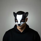 3D-printed badger mask on a person, showcasing distinctive black-and-white markings for cosplay and Halloween.
