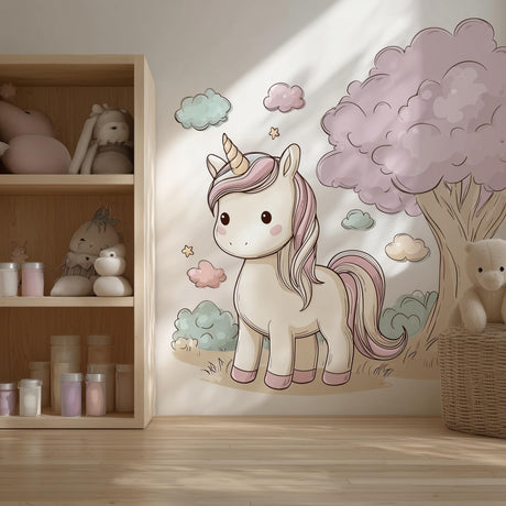 A cozy children’s room with a large wall decal of a pastel cartoon unicorn beside a fluffy pink tree and surrounded by soft clouds and stars. The design features a sweet and whimsical aesthetic in shades of cream, pink, and mint, perfect for a girl’s nursery or bedroom.
