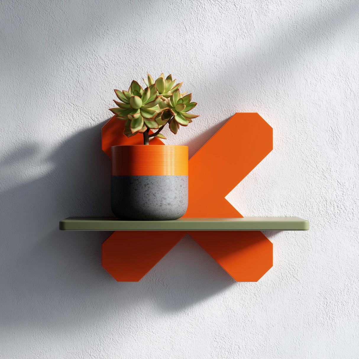 3D printed geometric X form wall shelf in orange with a green top, holding a potted plant, displayed as modern minimalist wall decor