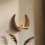 3D printed crescent moon-shaped wall shelf made of matte PLA plastic, holding a candle in natural light, minimalist modern home decor accessory