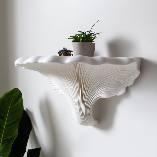 3D printed white shelf inspired by Turkey Tail mushroom, mounted on a white wall with fan-like texture and scalloped edge, decorated with a small potted plant.