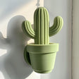 3D printed cactus-shaped wall decor made from matte PLA plastic, minimalist design inspired by nature, displayed on modern interior wall