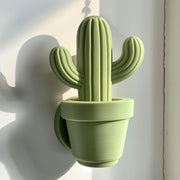 3D printed cactus-shaped wall decor made from matte PLA plastic, minimalist design inspired by nature.