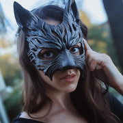 A woman wearing a black 3D printed werewolf-style masquerade mask, featuring intricate fur details and pointed ears.