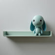 3D printed wall shelf with an integrated bunny character and a small plant pot beside it, made of matte PLA plastic and mounted on a light wall.