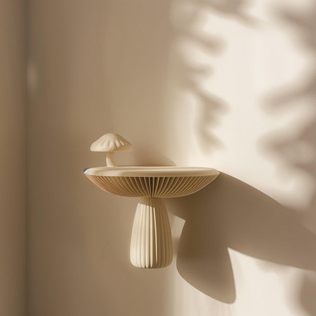 3D printed mushroom-shaped wall shelf made of matte PLA plastic, mounted on a softly lit wall, modern organic home decor accessory