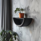 3D printed minimalist half-circle wall shelf with curved design and modern matte PLA finish, styled with a small plant