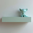 3D printed wall-mounted shelf with a smooth rectangular ledge and an integrated minimalist fantasy fox figure sitting on one end against a light wall.