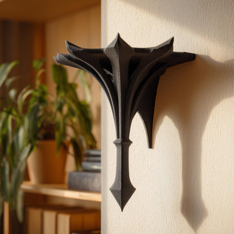 Small gothic-style 3D printed wall shelf bracket with a pointed spire shape, mounted on a light wall and used as a decorative display ledge.