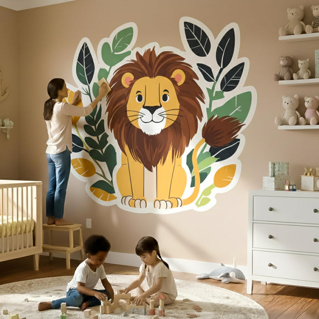 A cute, smiling cartoon lion with a brown mane sitting in front of a decorative wreath of dark green, light green, and orange leaves.