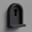 3D printed wall mounted shelf shaped like an arched niche with a keyhole cutout and a small front ledge, shown in matte dark finish on a neutral wall.