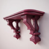 3D printed gothic-style wall shelf with ornate carved brackets and a flat floating ledge, mounted on a light minimalist wall.