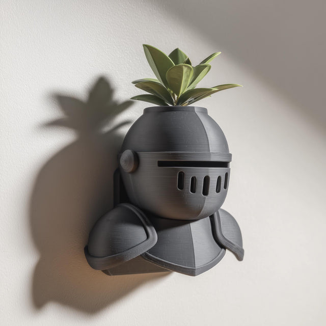 3D printed wall mounted knight helmet planter shelf with a small green plant, displayed on a light wall with soft natural shadows.