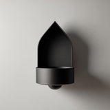 3D printed arched wall mounted shelf with a pointed backplate and a small integrated bowl tray, minimalist sculptural design on a clean wall.