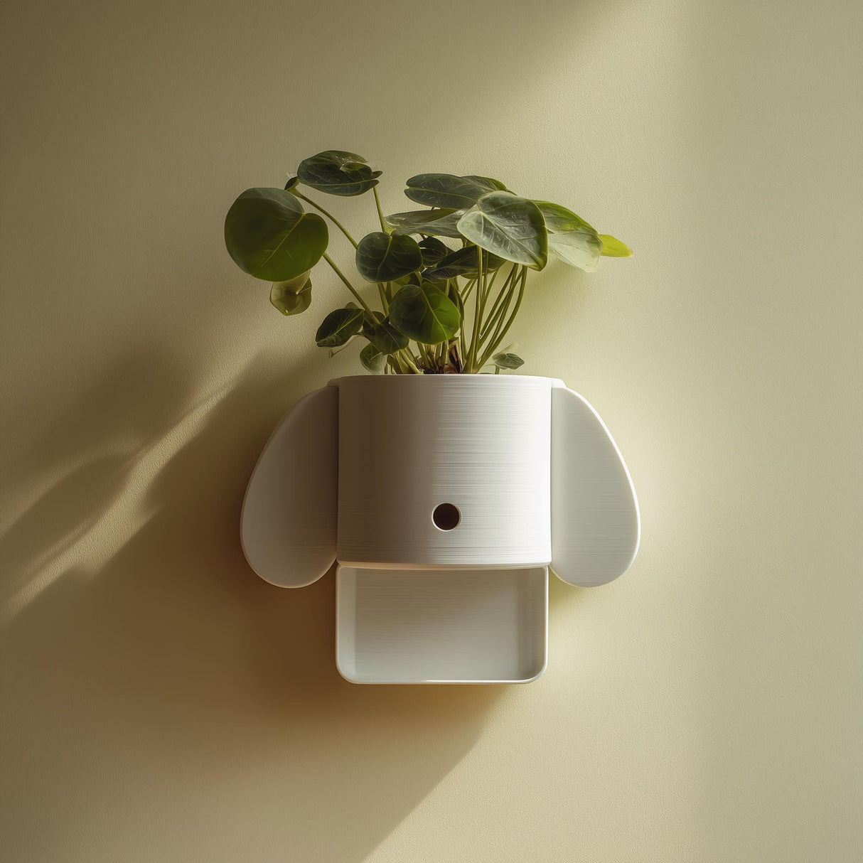 3D printed minimal dog-shaped wall planter shelf in matte white PLA mounted on a soft warm wall and holding a green houseplant.