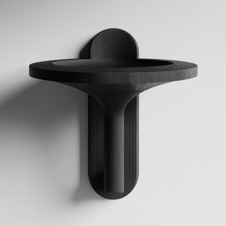 3D printed wall mounted bowl shelf with a wide round tray and sculptural vertical support, visible print texture, mounted on a clean studio wall.