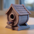 3D printed rustic birdhouse decor with wood-style texture and perch displayed on a wooden desk in a cozy interior setting.