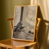 African Grey Parrot Reading in Bed Poster | Japanese Zen Ink Wash Bird Wall Art | Warm Ivory Fog Gray Decor | Minimalist Bedroom Print