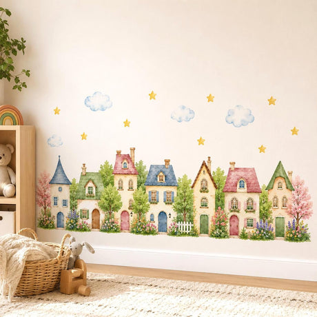 Watercolor wall vinyl decal of a cute row of pastel village houses with trees, flowers, clouds, and small yellow stars on a white background.