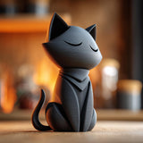 3D printed minimalist cat memorial urn with closed eyes and removable lid displayed on a wooden surface in warm ambient lighting.