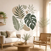 Tropical botanical wall decal with large green monstera and banana leaves beside soft beige abstract shapes.