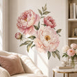 Watercolor arrangement of three large blush pink and cream peonies with one smaller bud, golden flower centers, and muted sage and olive-green leaves on a white background.