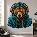 Bold illustrated brown bear with bright turquoise eyes wearing a deep teal hooded sweatshirt and large teal-and-orange over-ear headphones with orange drawstrings.