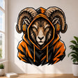 Bold illustrated ram with massive curled horns, intense amber eyes, and brown-and-tan facial shading, wearing a black-and-orange hooded sweatshirt and large black-and-orange gaming headphones.