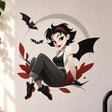 Gothic bat girl wall decal with black wings, three flying bats, a gray moon backdrop and burgundy leaves.
