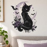 Black cat with purple eyes against a lavender crescent moon, framed by bats, stars, curling vines and a purple rose.