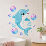 Cute blue dolphin with large sparkling eyes, rosy cheeks, a white belly, and a smiling expression, surrounded by iridescent pink, lavender, aqua, and blue bubbles, water splashes, and small star accents.