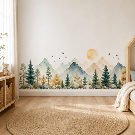 Wide watercolor-style landscape with sage and blue-gray mountains, evergreen trees, rocks, a golden sun and small birds.