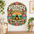 Retro floral wall decal with a seated figure, mountain landscape, peace signs and the wording Introvert Vibes, Quiet, Cozy, Peaceful, Home is the party.