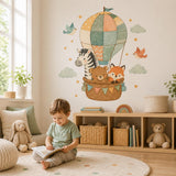 Woodland animal wall decal showing a zebra, sleeping bear and fox beneath a colorful patchwork balloon canopy.