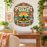 Retro homebody wall decal with the words Introvert Vibes and a seated figure among flowers, mountains and peace signs.