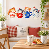 Four kittens in decorated teacups wall sticker above a cozy kitchen breakfast nook with cat-themed pillows and flowers.