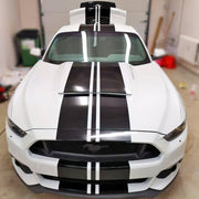 White car with sleek black racing stripes vinyl decals for sporty upgrade.