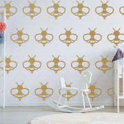 Bumblebee wall decals in a playful pattern on a nursery wall, featuring gold vinyl stickers.