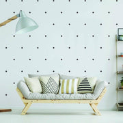 Stylish living room with black adhesive cross decals on the wall, featuring a cozy sofa and decorative pillows.