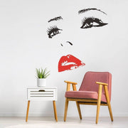 Elegant wall art decal of a woman’s face with red lips.