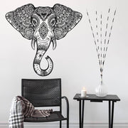 Elephant head wall vinyl sticker featuring Aztec geometric design above a chair and side table with decor.