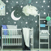 Nursery featuring 233x white stars wall vinyl stickers and moon decal on a dark wall with a crib and decorative elements.