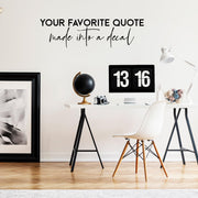 Custom text quote decal on a wall above a stylish desk, showcasing personalized decor in a modern workspace.