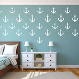 Vinyl vintage anchor wall decals in white on a blue wall, enhancing a nautical-themed bedroom decor.